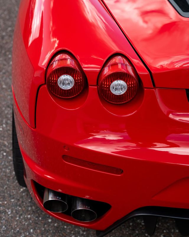 a close up of the back of a red sports car